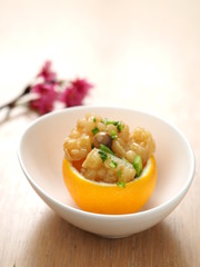 Orange cake with pork in white bowl in asian restaurant