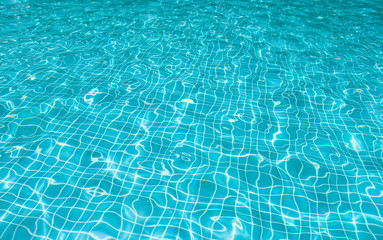 Blue ripple water in swimming pool with sunny reflections, Thailand