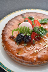 Special cake with blackberry and strawberry on white plate in re