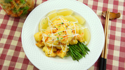 Fried bread with asparagus on white plate on the caro table