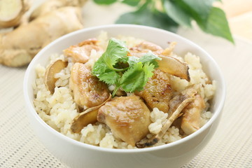 Fried rice with chicken and herbs in white bowl in restaurant