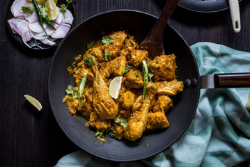 Zero oil indian chicken curry in black pan on the table