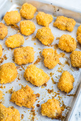 Tortilla crusted baked fish bites on plate