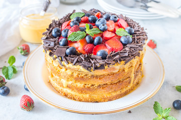 mango fruit cream cake with chocolate berry strawberry and mint