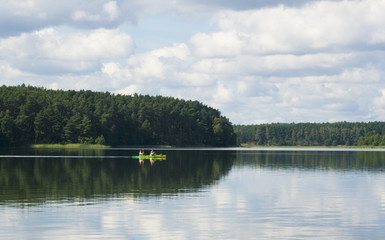 couple in cajak and Beutifull view of a lake with Sky reflection in the lake