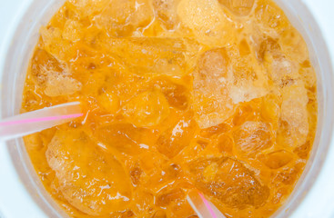 thai iced tea with milk in a thermos.