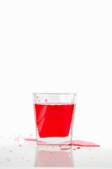 Pouring red sparkling wine in a glass  isolated on white background