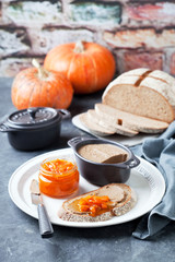Fototapeta na wymiar Liver pate and pumpkin orange marmalade on toast whole grain bread, selective focus