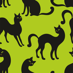 Vector seamless pattern with the image of the silhouettes of beautiful graceful cats