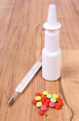 Pills, thermometer and nose drops and for colds, treatment of flu and runny