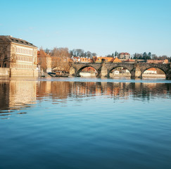 Prague, Charles bridge reflected in Vltava river in the morning