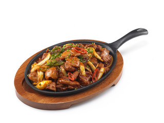 Korean style of beef soup called Hella buldak on black pan on wo