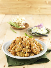 Garlic fried chicken sunsal on white plate with herbs