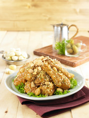 Crispy garlic fried chicken sunsal on white plate with herbs