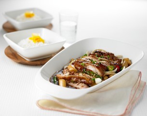 Mixing soy fried chicken with rice on white background