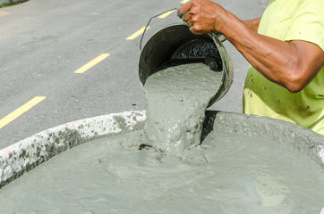 Worker pouring cement in construction site