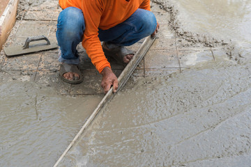 Workman plaster at construction site,Concrete pouring during commercial concreting floors of buildings in construction(Commercial Building)