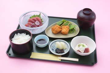 Tray meal of Japanese style with rice, sushi and soy sauces