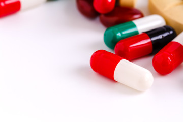 Many pills and pill bottle isolated on white background
