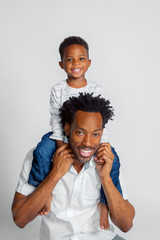 A Young African American Boy Sits Atop the Shoulders of His Dad
