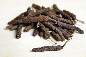 Long pepper or Pipli or Dipli (Piper longum) isolated on wood ba