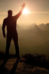 Fototapeta premium Man takes phone photos.Dreamy fogy mountains while sunrise