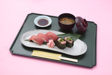 Fototapeta na wymiar Trau meal of sushi and miso soup in Japanese style in white background