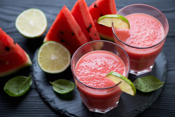 Close-up of watermelon smoothie and slices of ripe watermelon