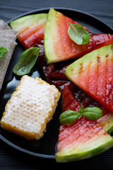Closeup of barbecued watermelon slices with addition of honey