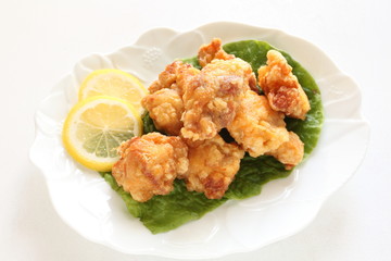 Japanese food of Karaage with lemon and salad on white plate