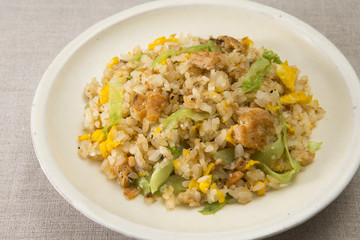 Fried rice with minced chicken and eggs on white plate