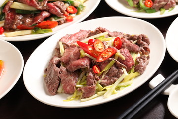 Chive fried beef with chili and onion on white plate in restaura