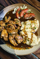 chicken breast with brown gravy sauce and mashed potato