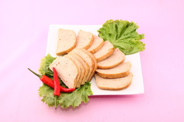 Sliced vietnamese sausag or cha gio with chili and lettuce on wh