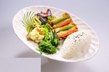Shrimp rolls with rice with vegetable on white plate in white ba