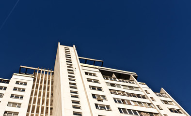 Fototapeta premium Residential building against blue sky with plase for your text.