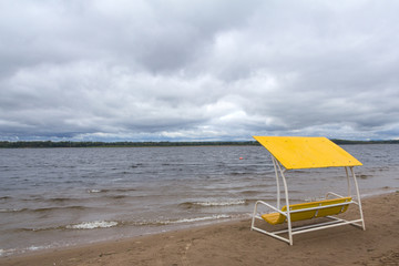 Yellow Beach bench on the bank of the river