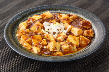 Mabo tofu with tomatoes soup and onion on chinese plate