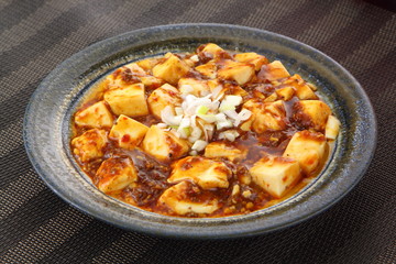 Mabo tofu with tomatoes soup and onion on chinese plate