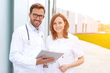 Two doctors working in front of the clinic