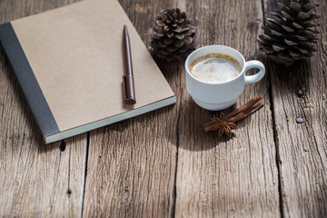 coffee cup and cinnamon sticks on old wooden table