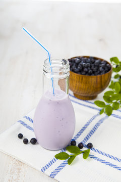 Bilberry smoothie on a wooden table