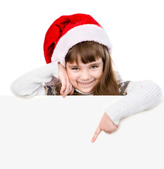 Happy Christmas girl with santa hat points down. isolated on white