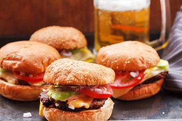 Beef hamburgers with salad of tomatoes and onion with beer