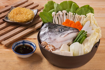Hot pot of salmon head with mushroom, carrot, tofu, cabbage and