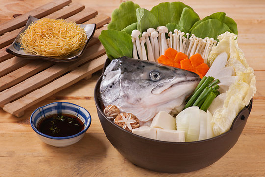 Hot pot of salmon head with mushroom, carrot, tofu, cabbage and