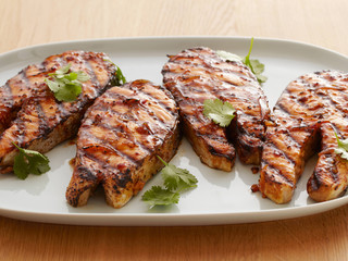 Miso Ginger Marinated Grilled Salmon on white plate with herbs