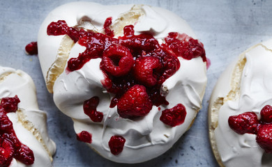Raspberries with white cream on grey background