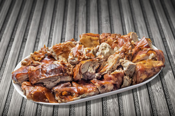 Plateful of Spit Roasted Pork Slices On Old Bamboo Mat