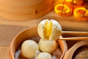 Chinese dumplings with yellow egg inside on bamboo tray